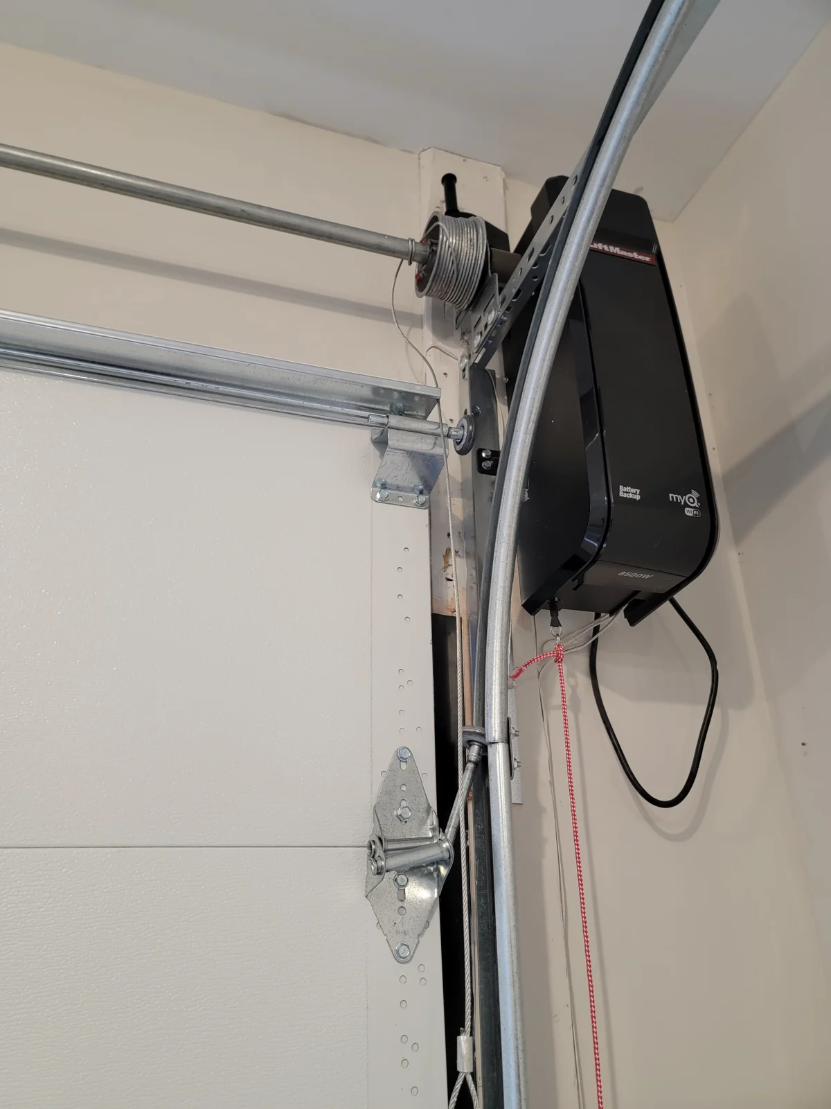 The same wall-mount opener from a wider angle, with the shaft and drum.