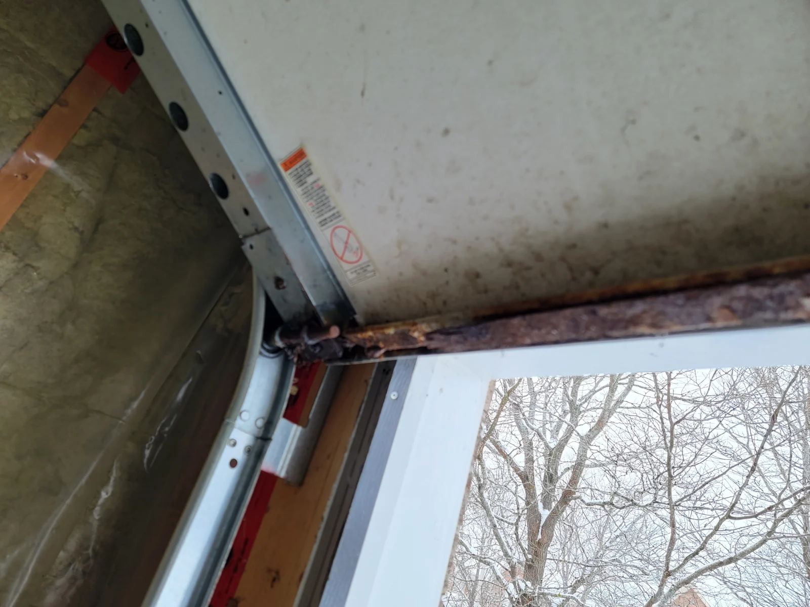 Before: Corroded bottom-retainer corner before replacement.