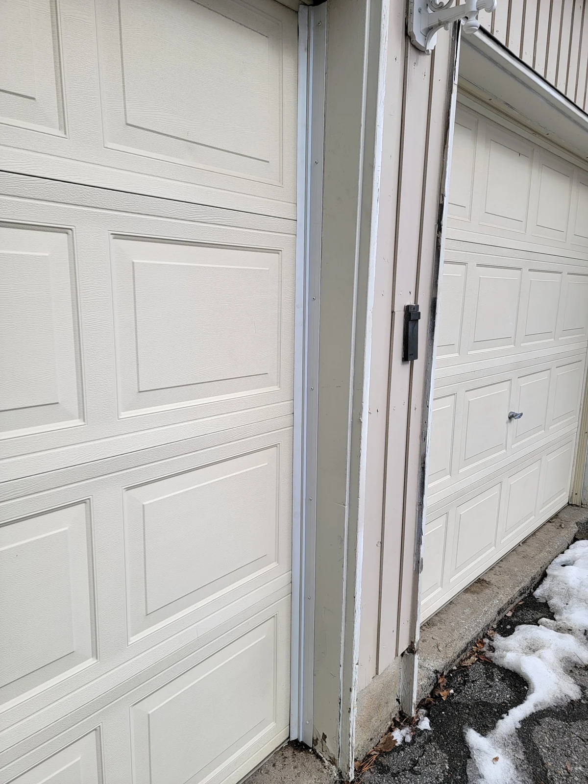 After: Refitted perimeter weather strip at the same garage opening.