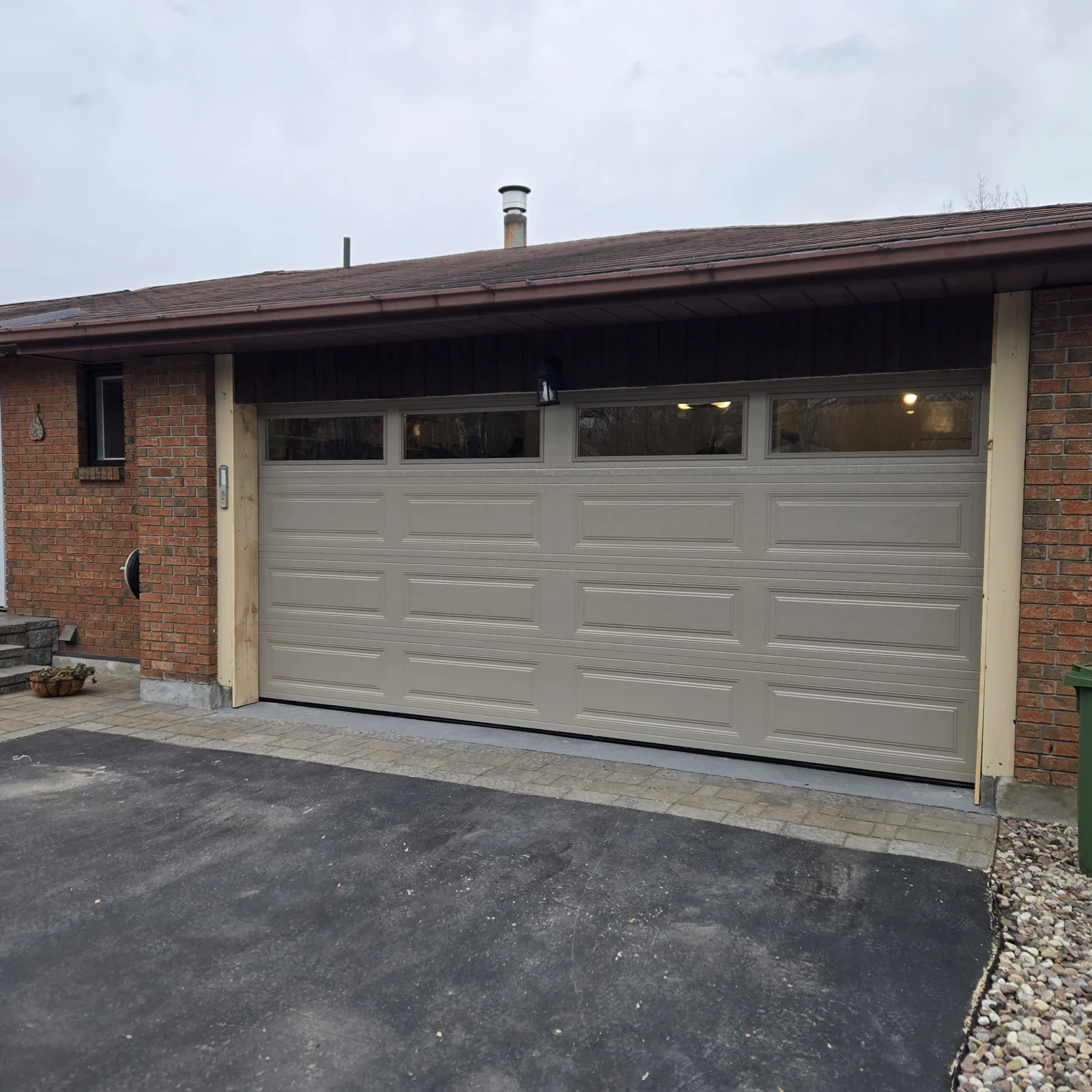 After: Long-panel double garage door with a top row of windows.