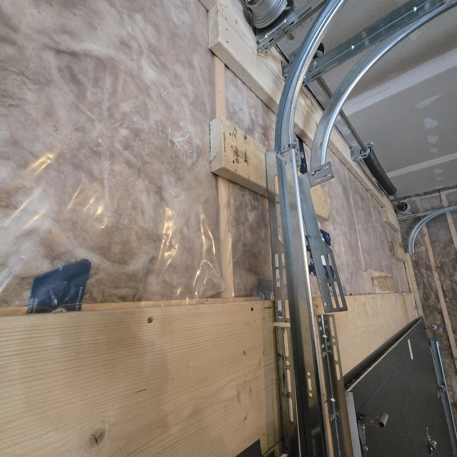 Timber blocking supporting the garage door track hardware.