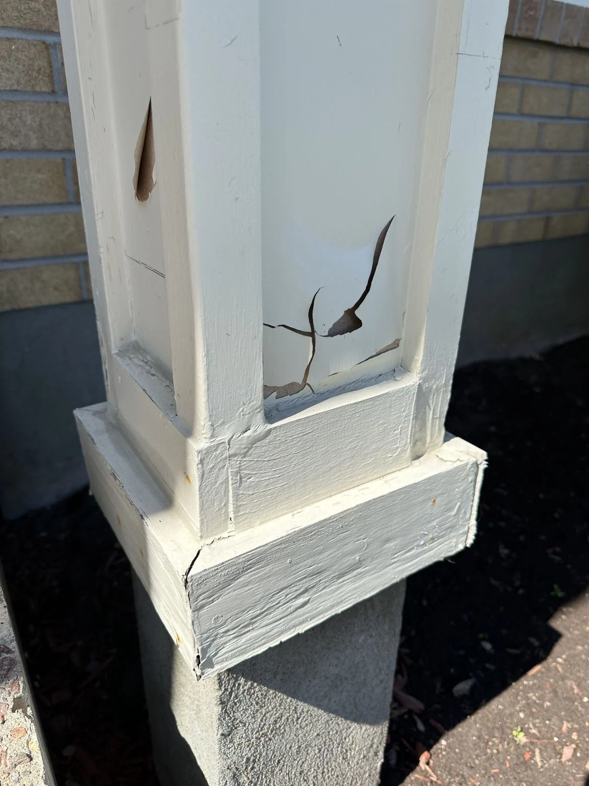 Before: Weathered painted column base before capping.