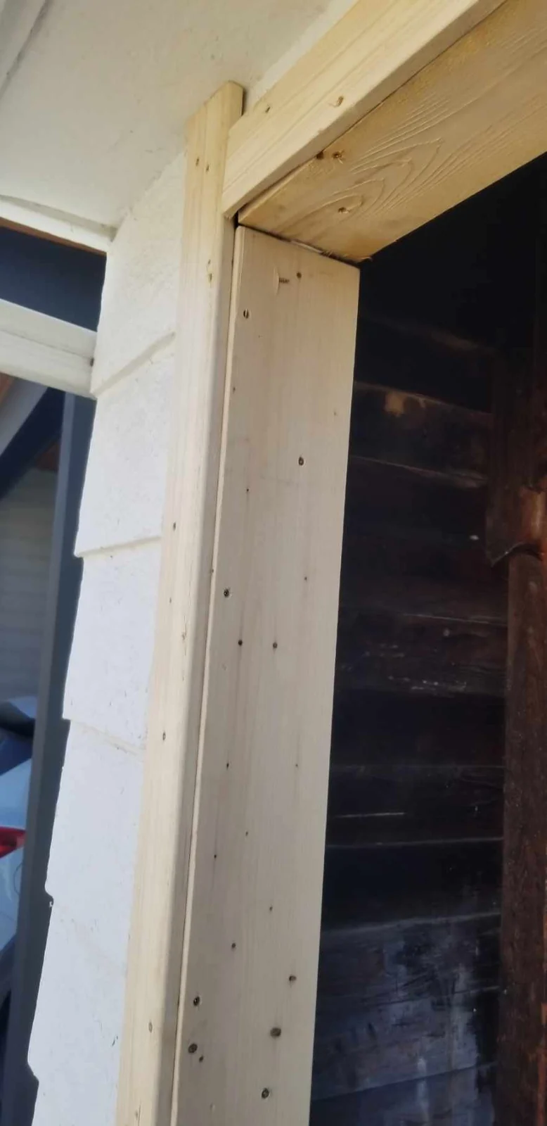 New timber jamb and header boards at a garage opening during framing work.