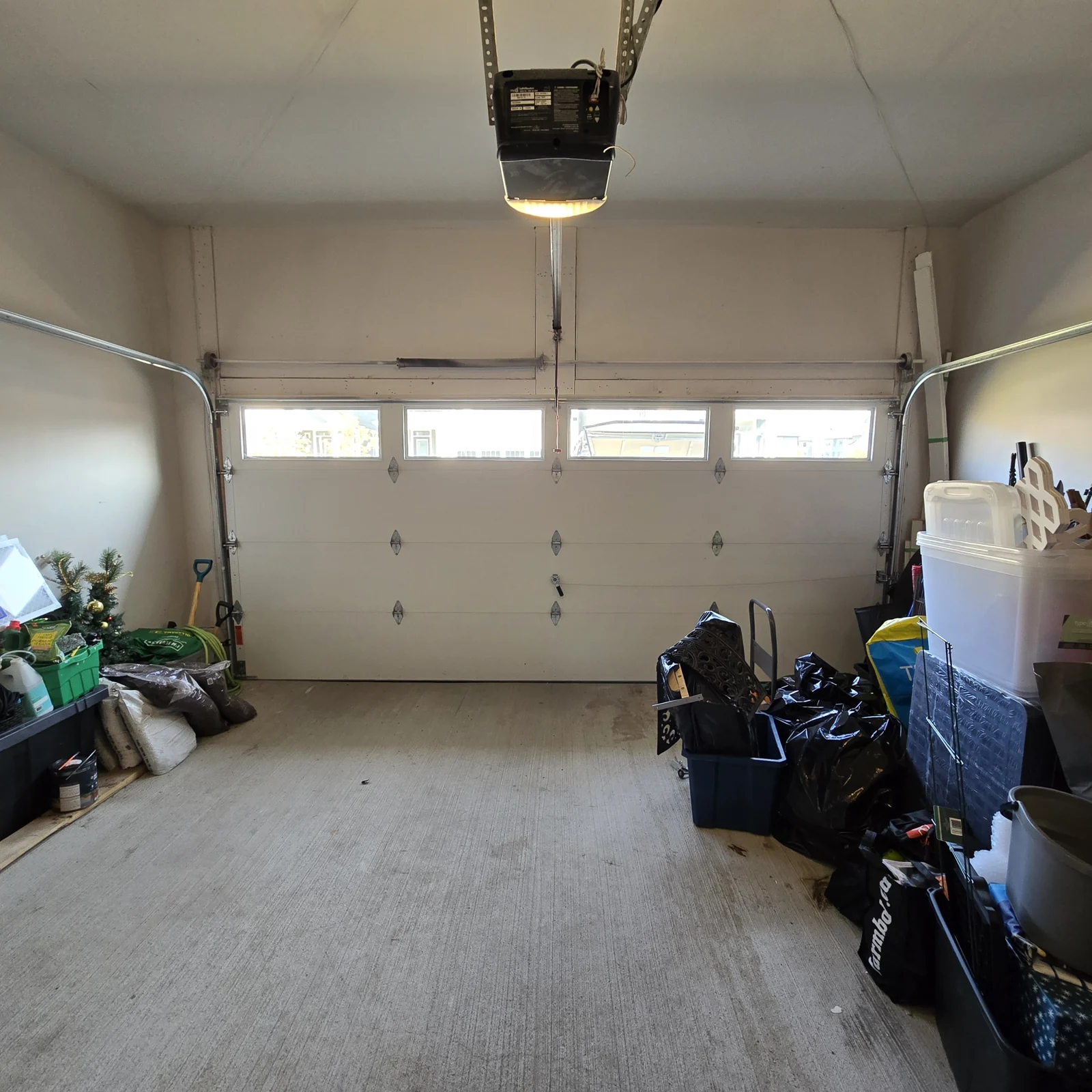 Interior view of a white sectional garage door aligned and closed after the pictured repair sequence.