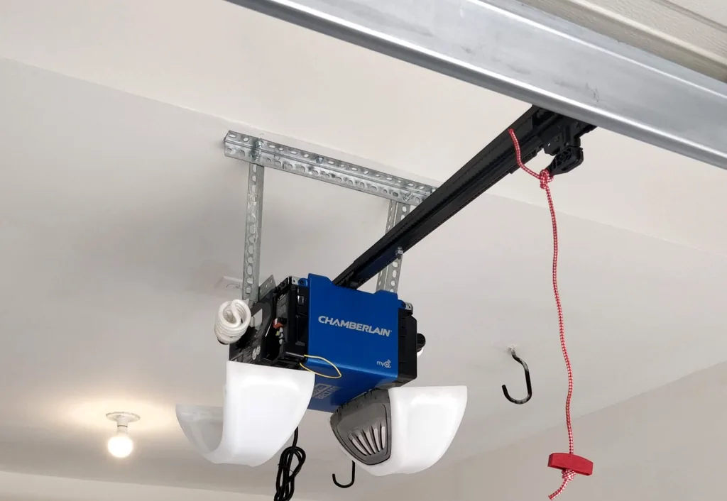 Ceiling-mounted Chamberlain garage door opener and rail installed in a residential garage.